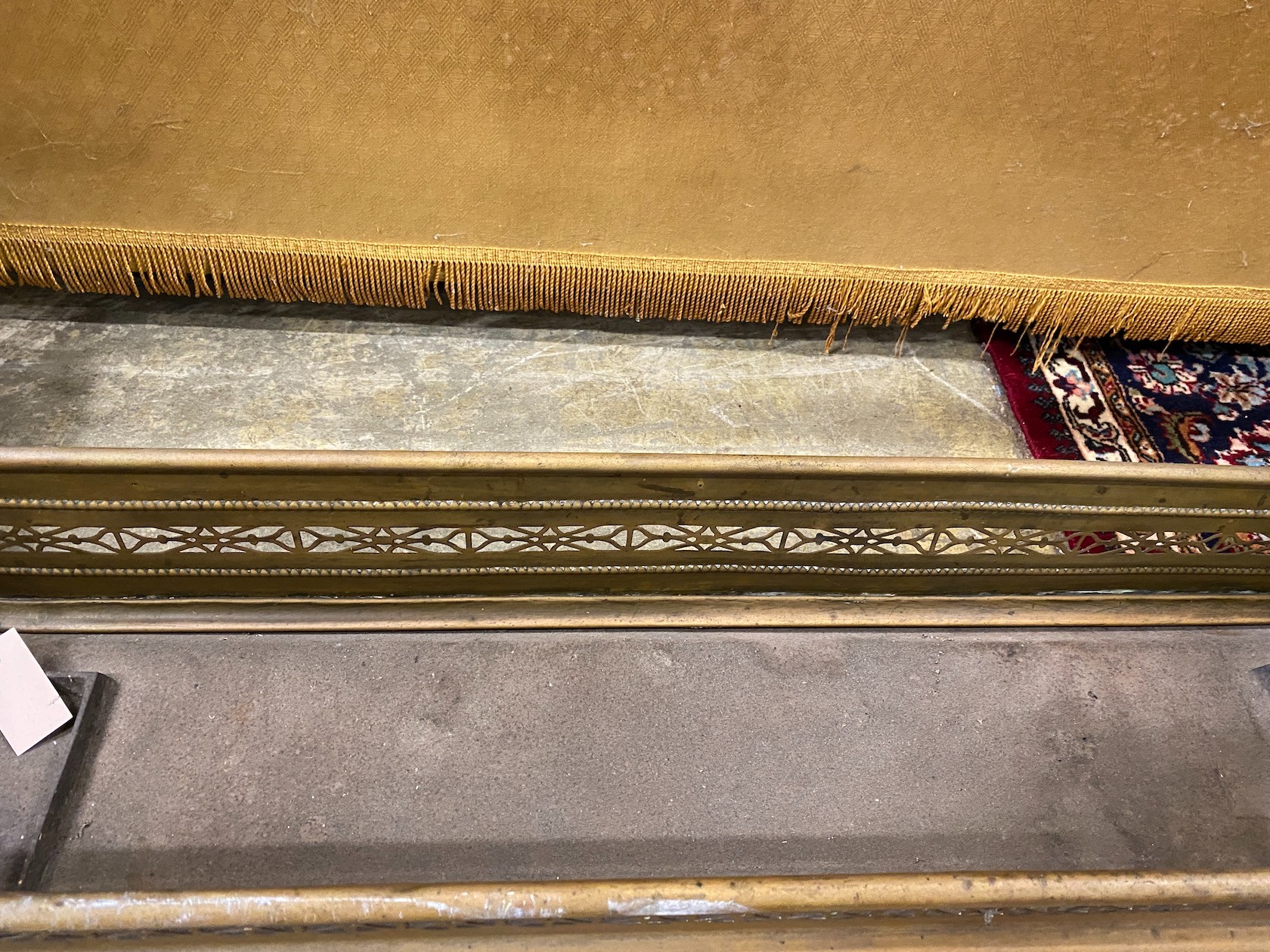 Two Victorian pierced brass fenders, larger width 121cm
